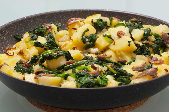 Guarnición de patatas con espinacas y anchoas